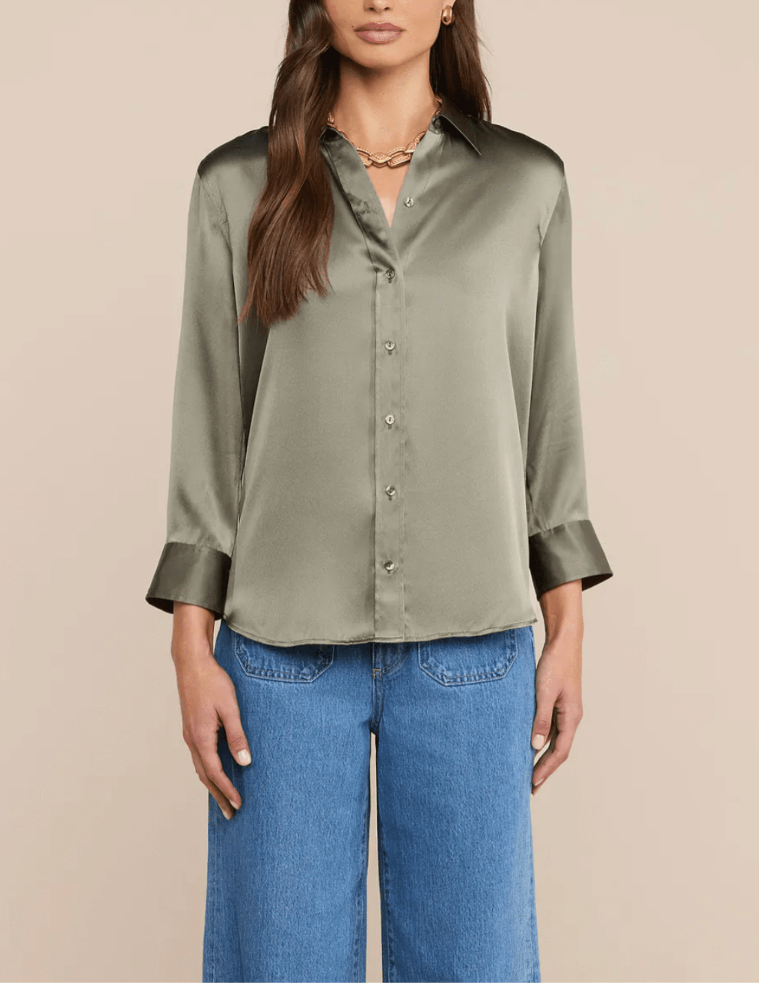 Model wearing L'AGENCE Dani silk blouse in Smokey Olive with wide-leg jeans