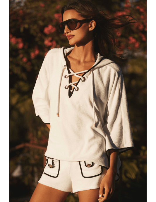 Model wearing LAGENCE Demeter white hooded poncho cover up
