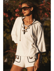 Model wearing LAGENCE Demeter white hooded poncho cover up