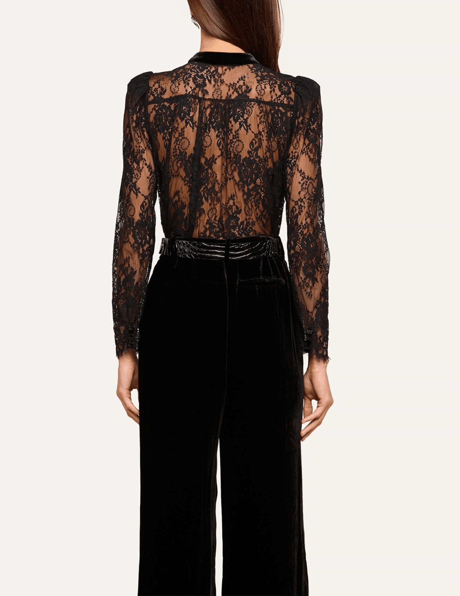 Back view of L'AGENCE Dorothea black Chantilly lace blouse showing sheer floral detailing and long sleeves.