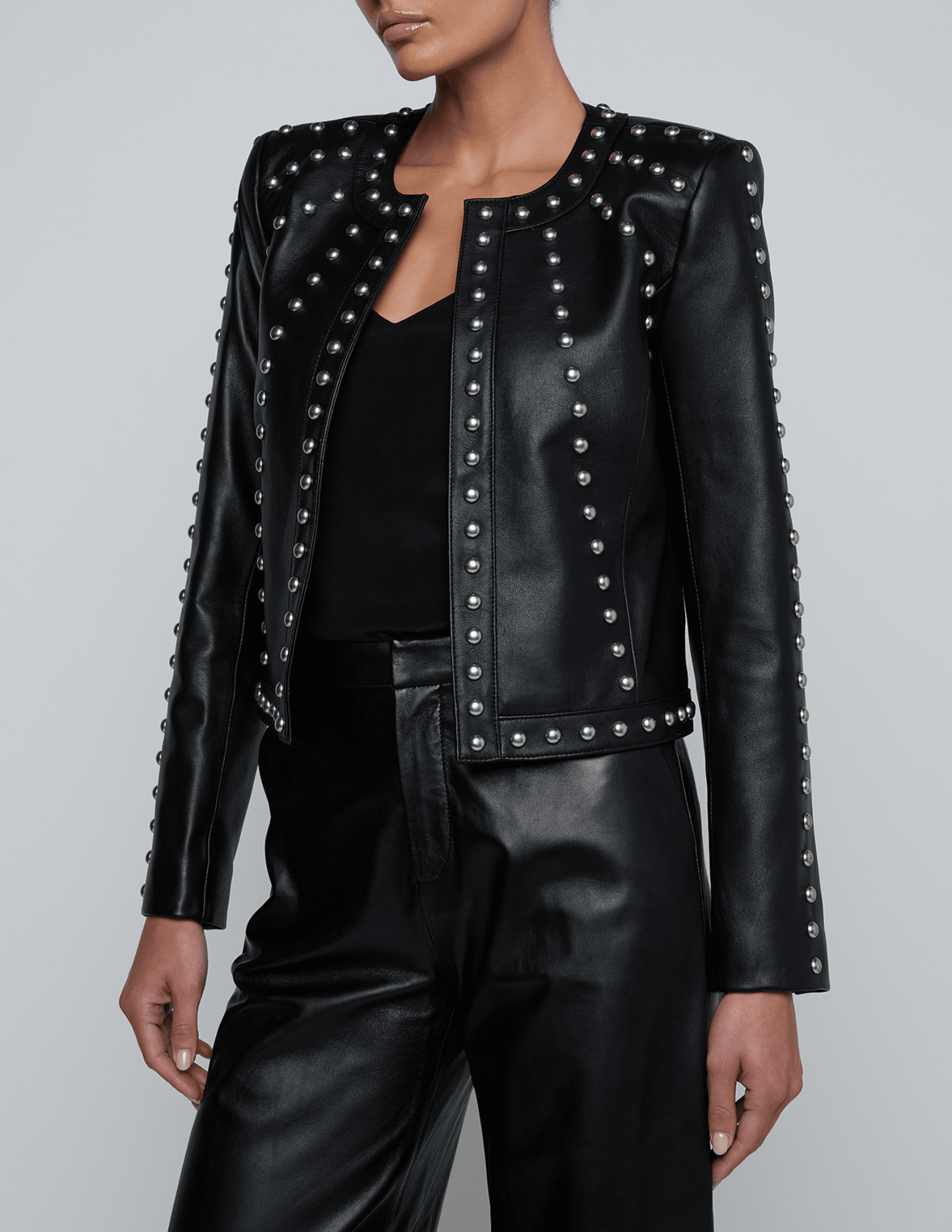 Side view of boxy fit L’AGENCE leather jacket with silver studs.