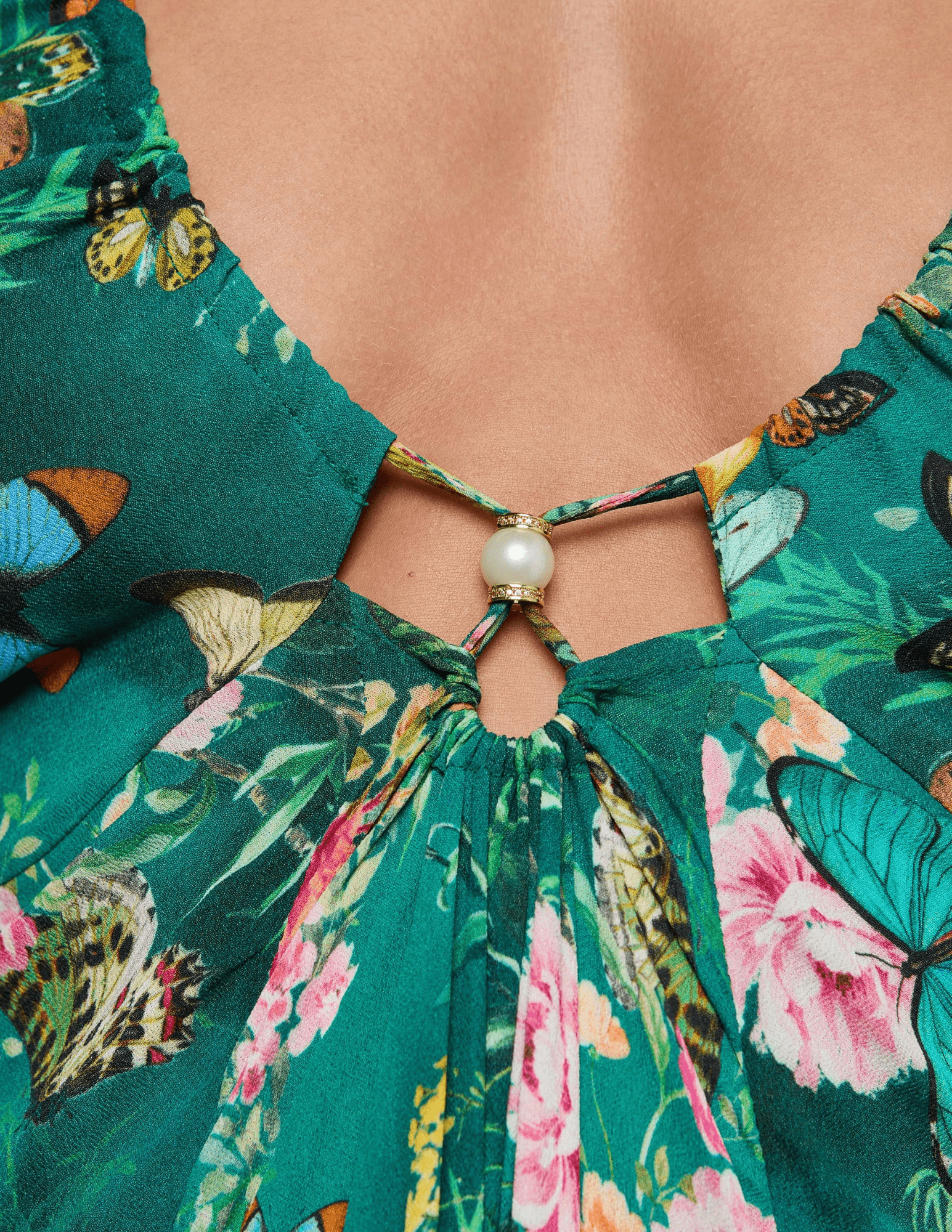 Close-up of faux pearl accents on L’AGENCE Geneva Halter Maxi Dress