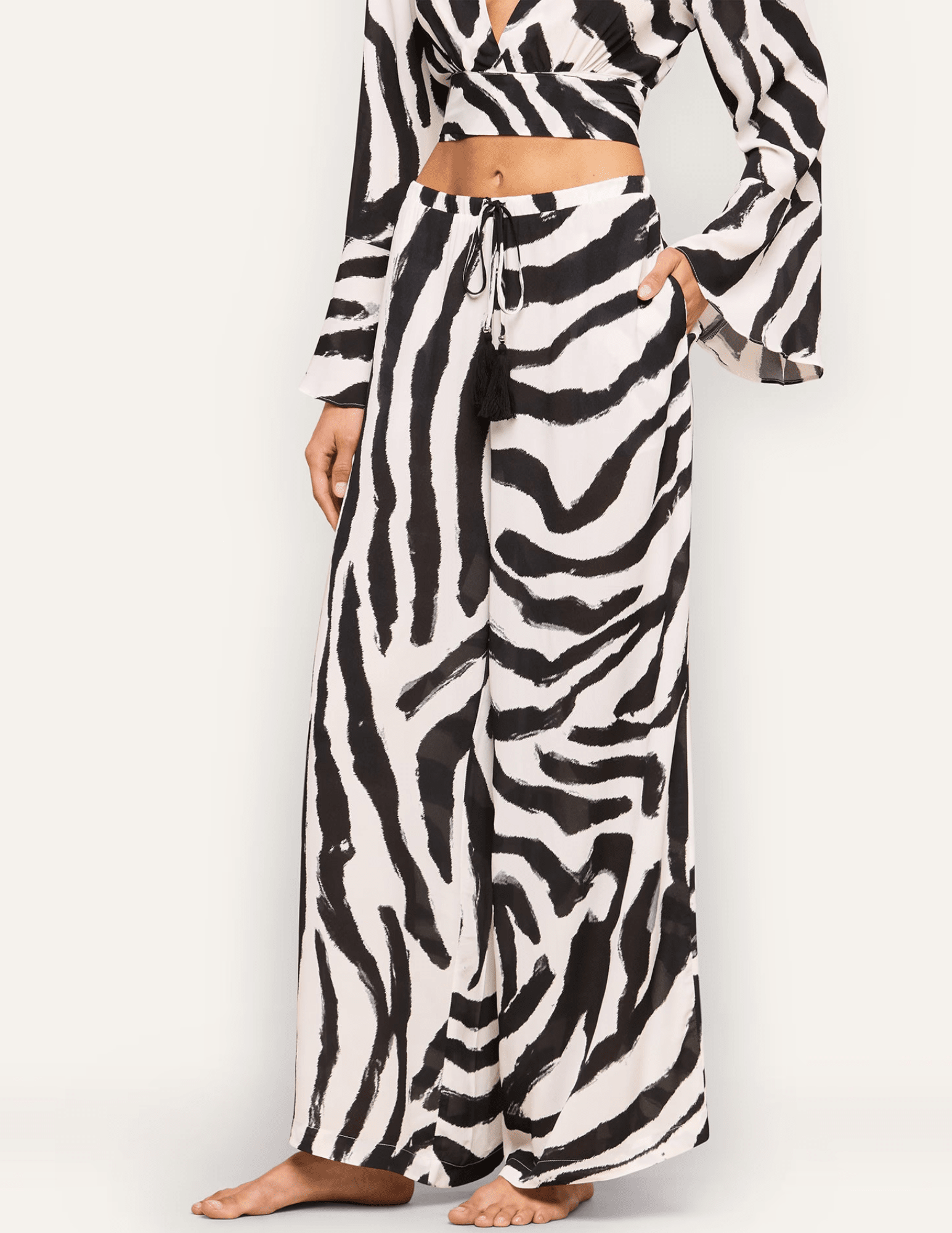 Side view of L'AGENCE Geraldine wide-leg zebra print resort pants.