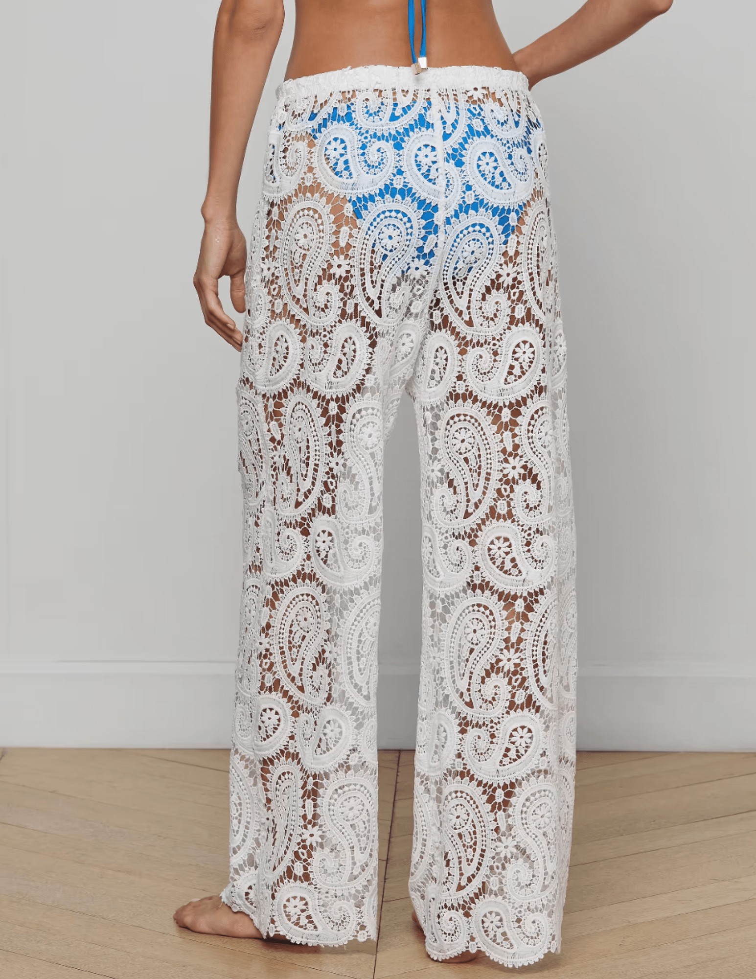 Model wearing L’AGENCE Geraldine white crochet cover-up pants- back