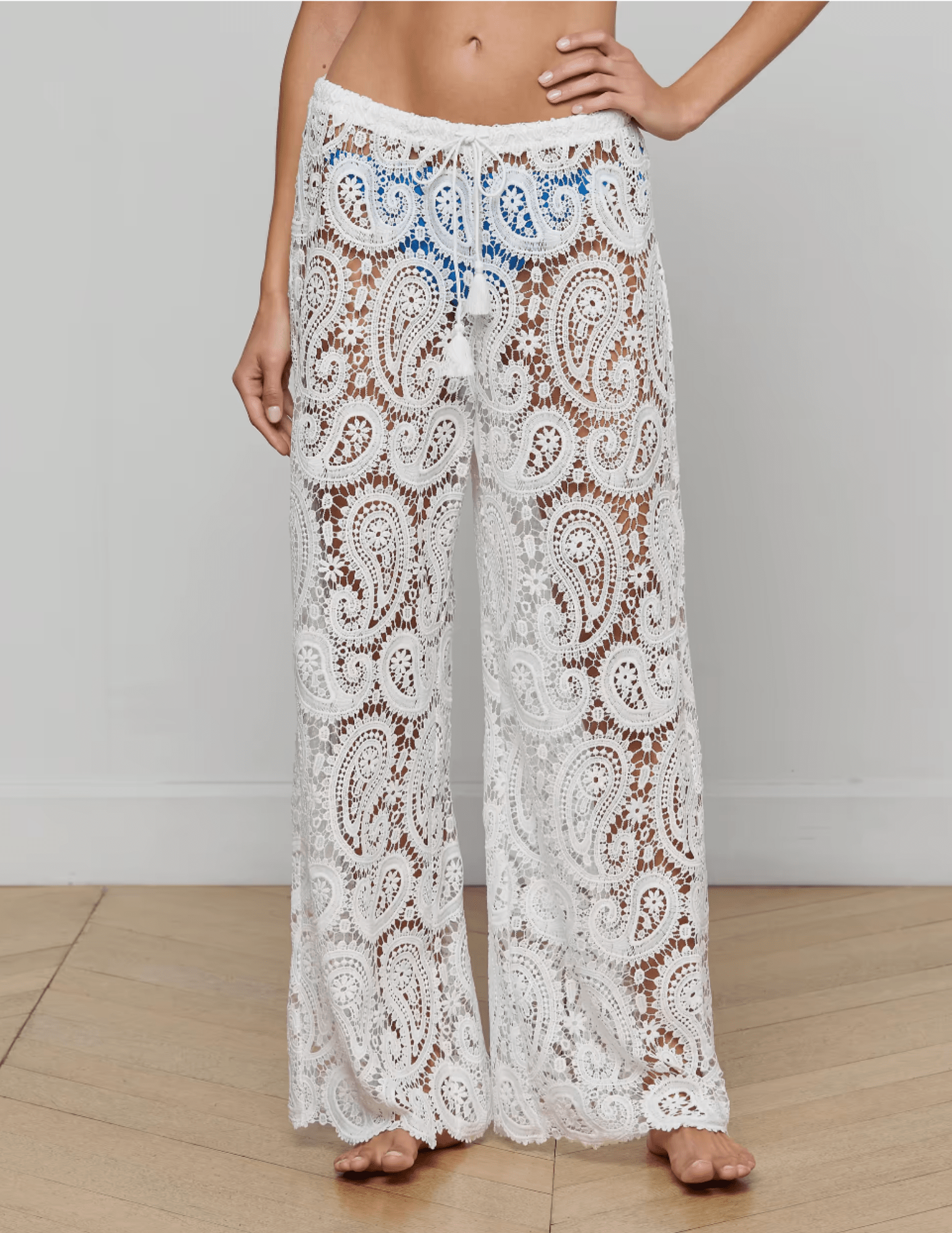Model wearing L’AGENCE Geraldine white crochet cover-up pants front