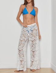 Model wearing L’AGENCE Geraldine white crochet cover-up pants