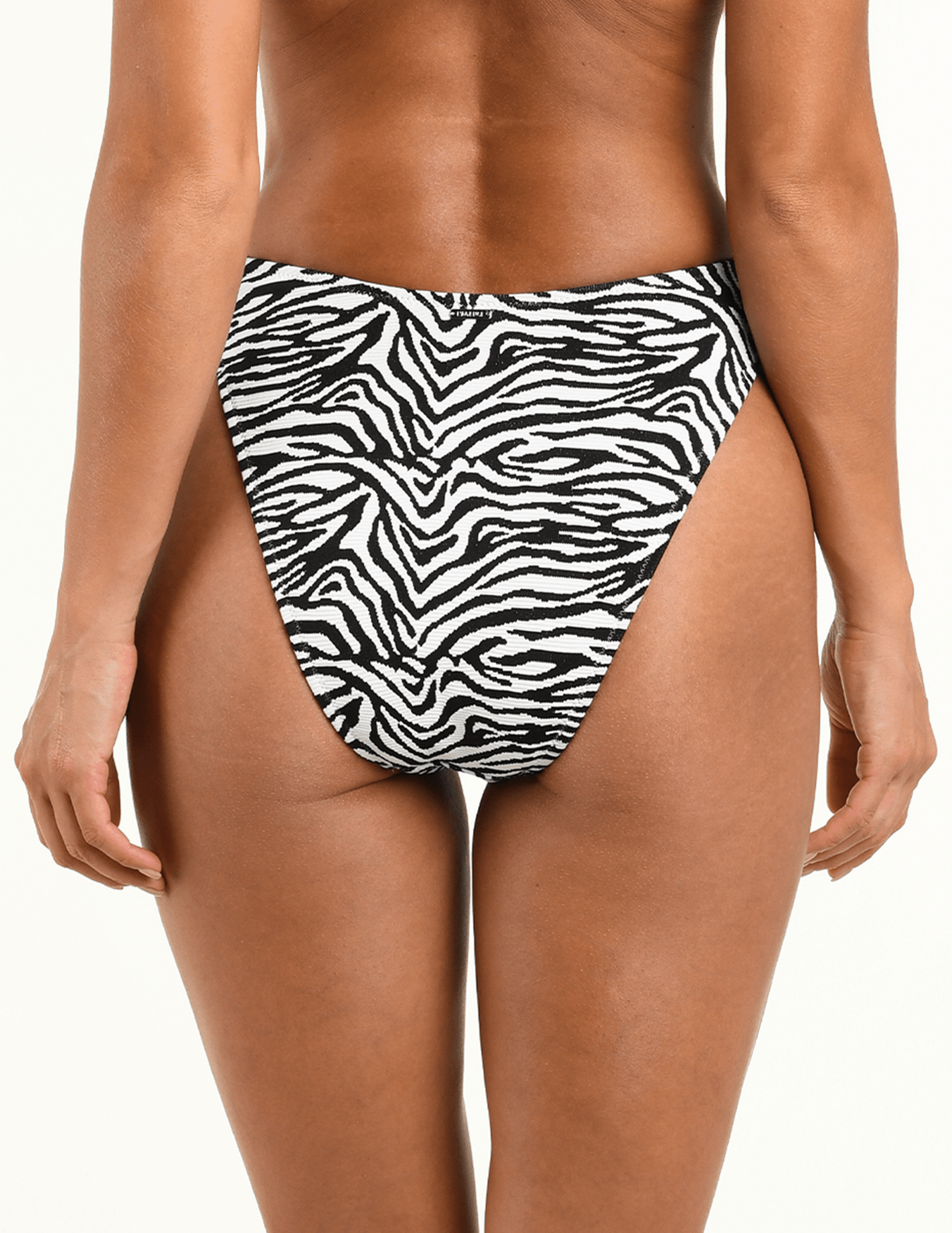 Back view of L'AGENCE Gianna Brazilian bikini bottom showcasing cheeky coverage and zebra print.