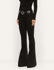 Angled view of L'AGENCE Her Story saturated black stretch denim jeans with a slim thigh and flared leg