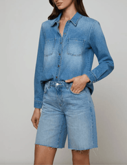 Side view of L'AGENCE Isla long sleeve denim shirt in Anaheim indigo wash