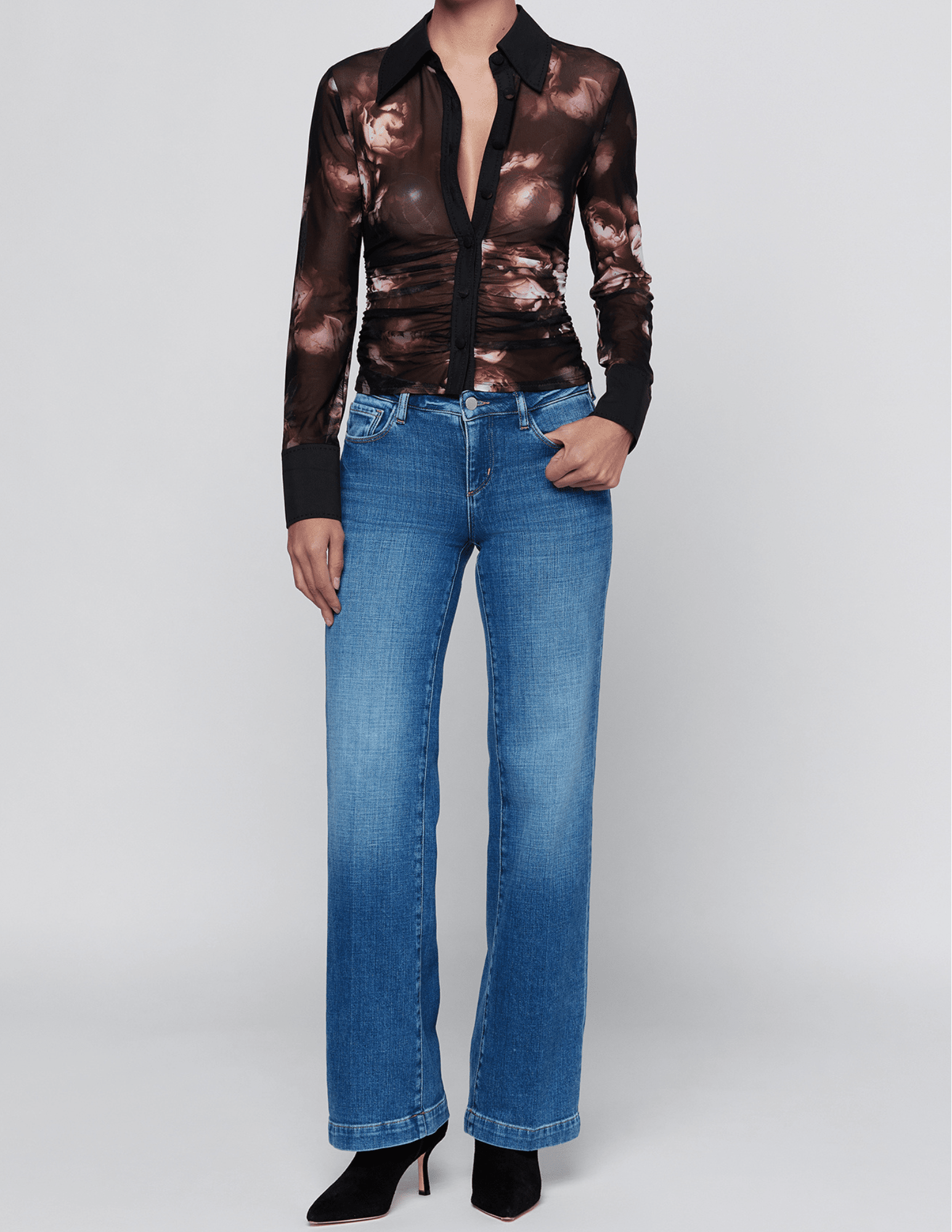 L'AGENCE Isola floral mesh top styled with straight-leg blue jeans and black heels.