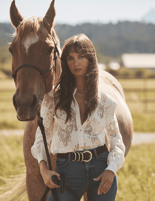 Editorial image of L’AGENCE Jenica Chevron Lace Blouse in Ivory