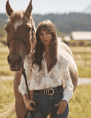 Editorial image of L’AGENCE Jenica Chevron Lace Blouse in Ivory