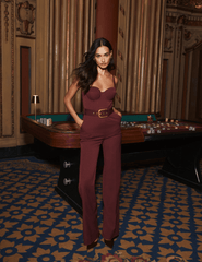 Model styling L'AGENCE Jessa Bustier Jumpsuit in Deep Port with statement belt