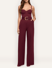 Model wearing L'AGENCE Jessa burgundy bustier jumpsuit with wide-leg pants
