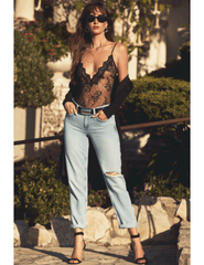 Model wearing black Chantilly lace bodysuit with jeans