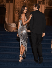 Model wearing L'AGENCE Karma silver sequin evening gown at an elegant formal event