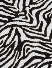 Close-up of textured black and white zebra print fabric on L'AGENCE Karmin swimsuit.