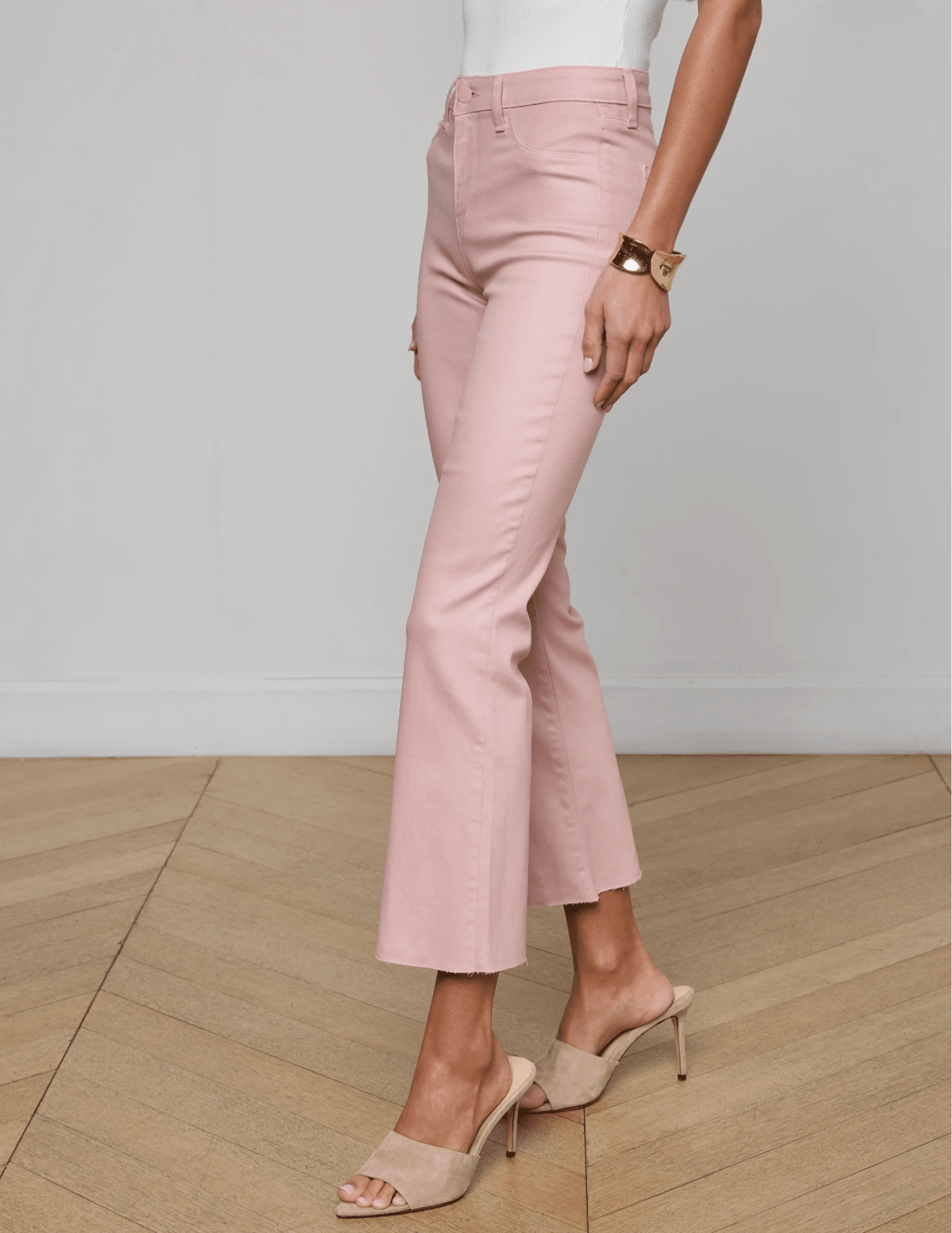 Side view of L’AGENCE Kendra pink coated cropped flare denim