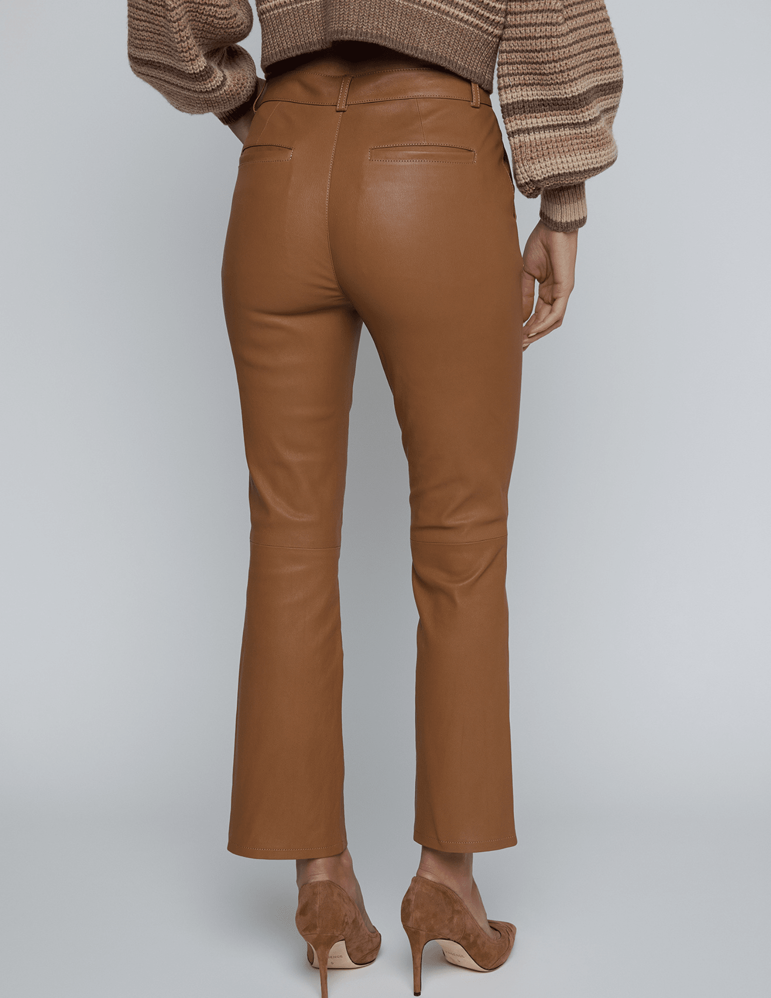 Back view of Ketra Leather Bootcut Trouser in Cognac with cropped hem.