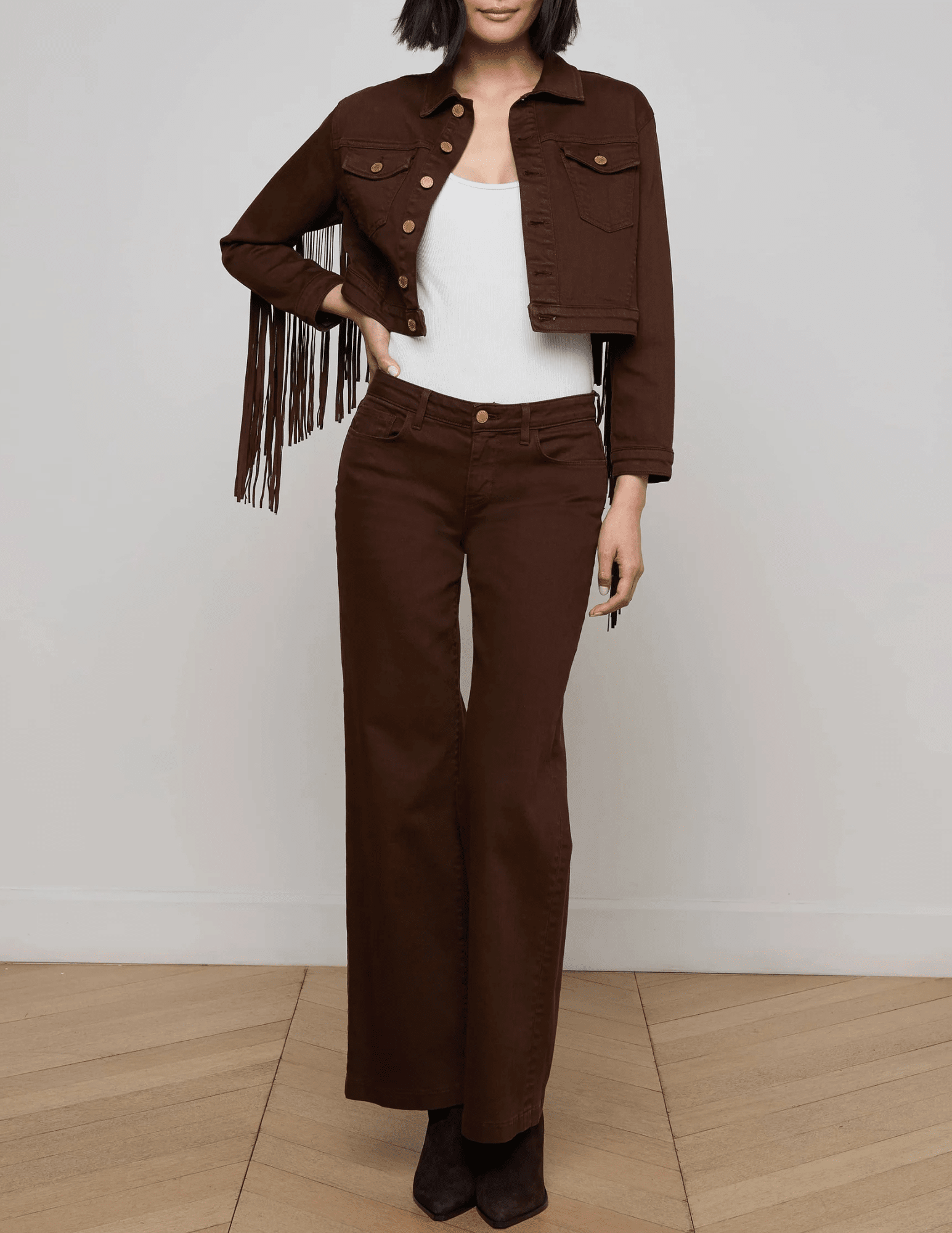 Front view of L’AGENCE Koda cropped denim jacket in brown with fringe and gold rivet buttons