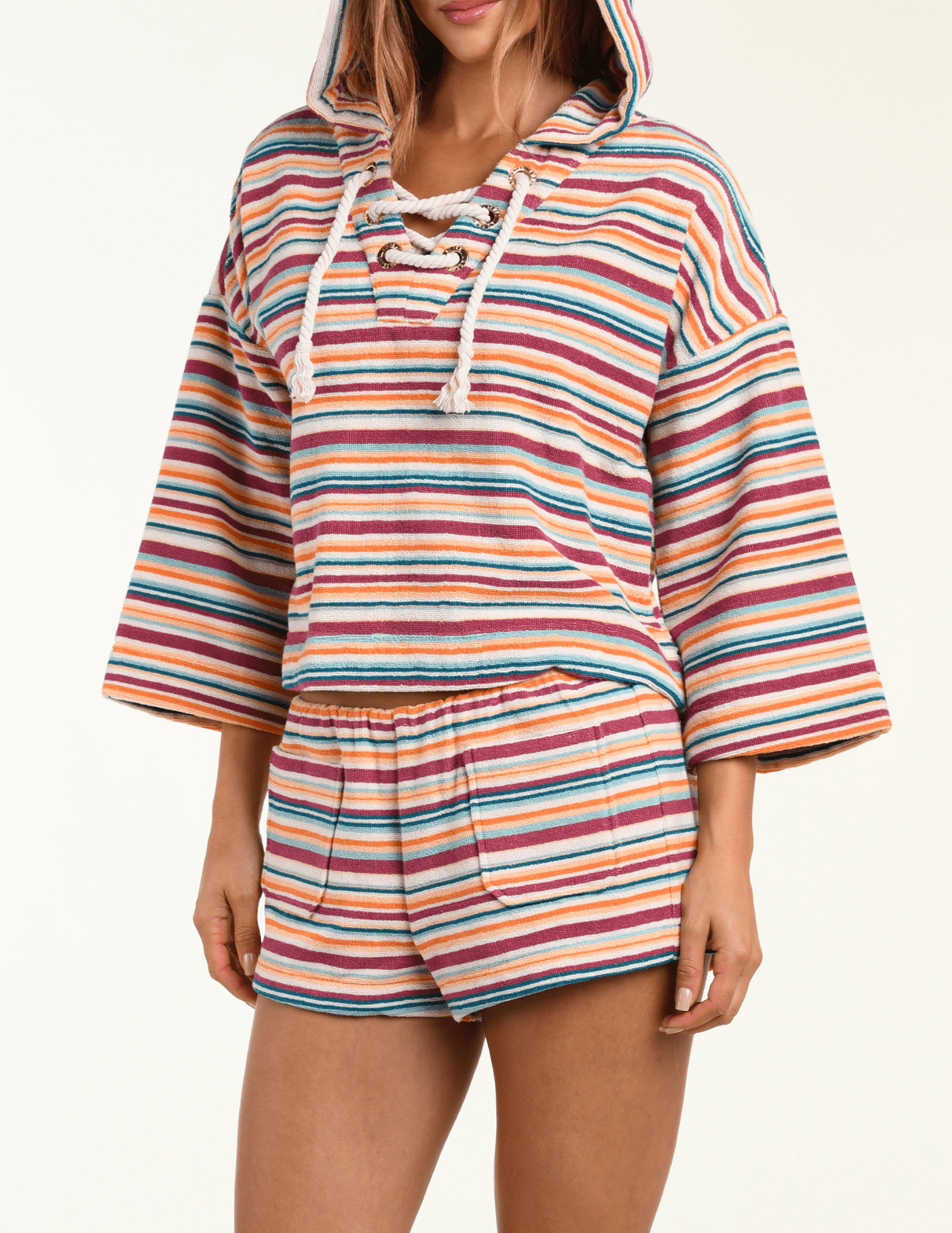 Side view of L’AGENCE Lee terry cropped hooded poncho in multicolor watercolor stripe
