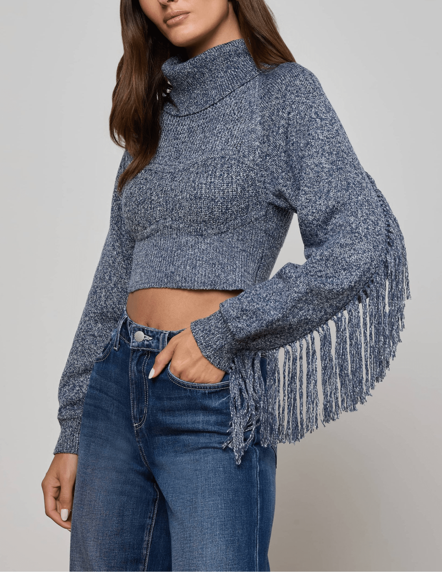 Side view highlighting long fringe detail cascading down sleeves