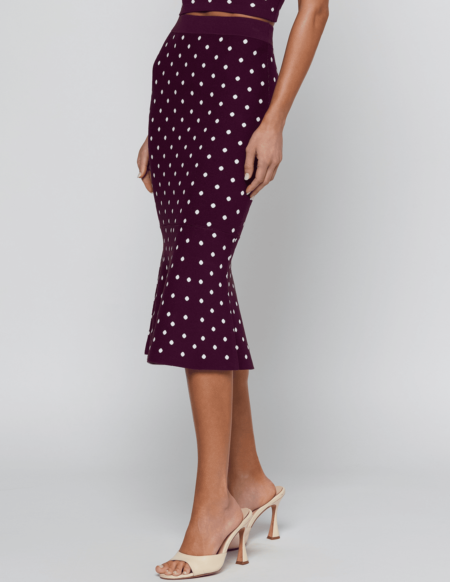 Side view of L'AGENCE Mae Knit Flare Skirt in Plum Ivory Polka Dot.