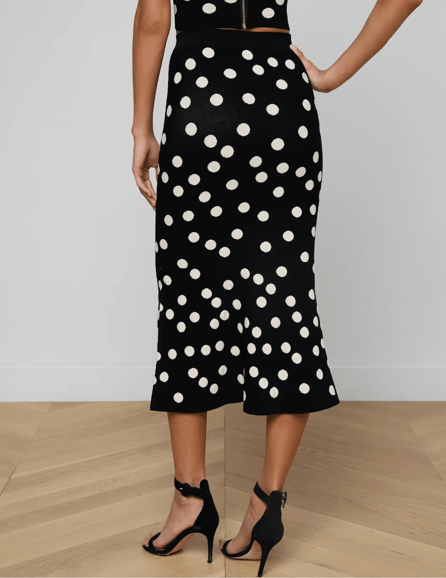 Back view L'Agence Mae knit midi skirt in black ecru polka dot