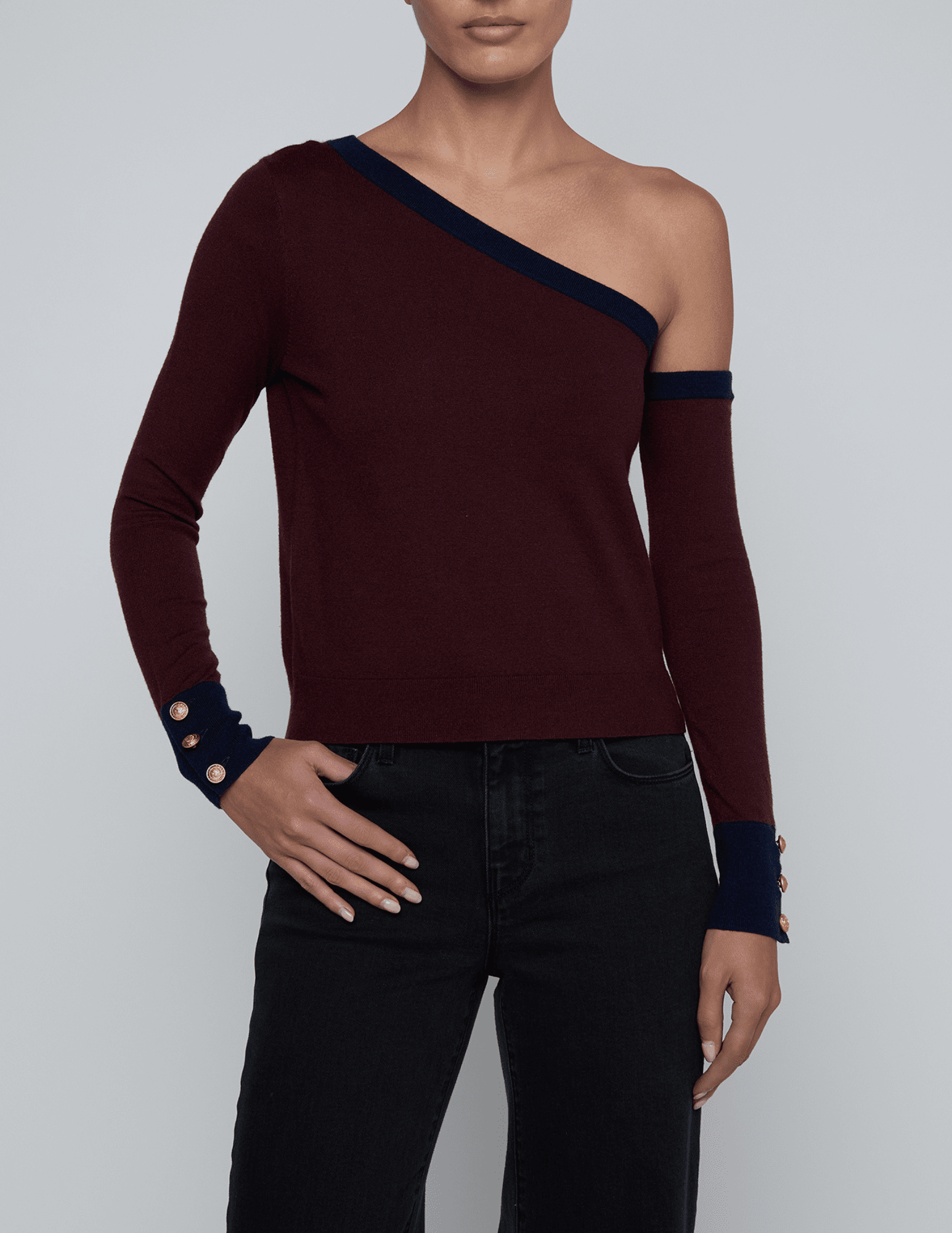 Front view of L’AGENCE Maeva One Shoulder Color-Block Sweater in Malbec and Midnight