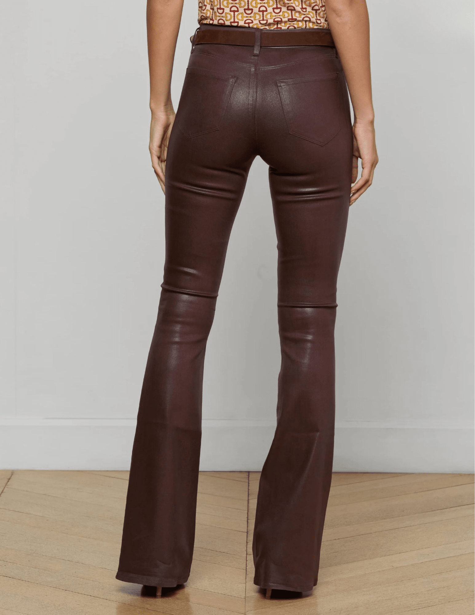 Back View of L’AGENCE Marty Ultra High Rise Coated Chocolate Flare Jeans on Model