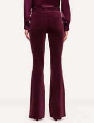 Back view of L'AGENCE Marty Velvet Ultra High Rise Jeans in Deep Sangria featuring classic back pockets and flared legs.