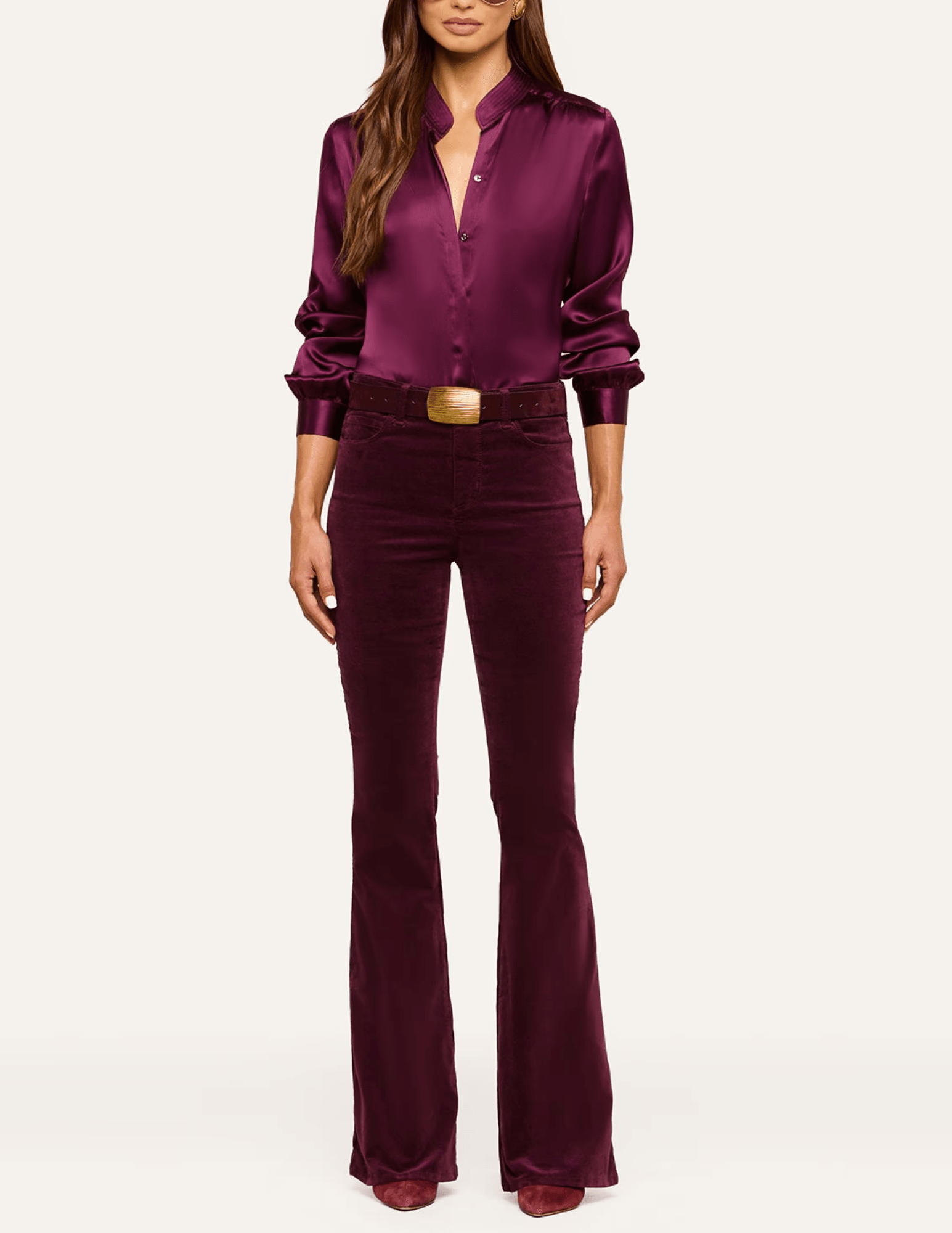 L'AGENCE Marty Velvet Flared Jeans in Deep Sangria styled with a matching burgundy blouse and gold statement belt for an elegant monochromatic outfit.