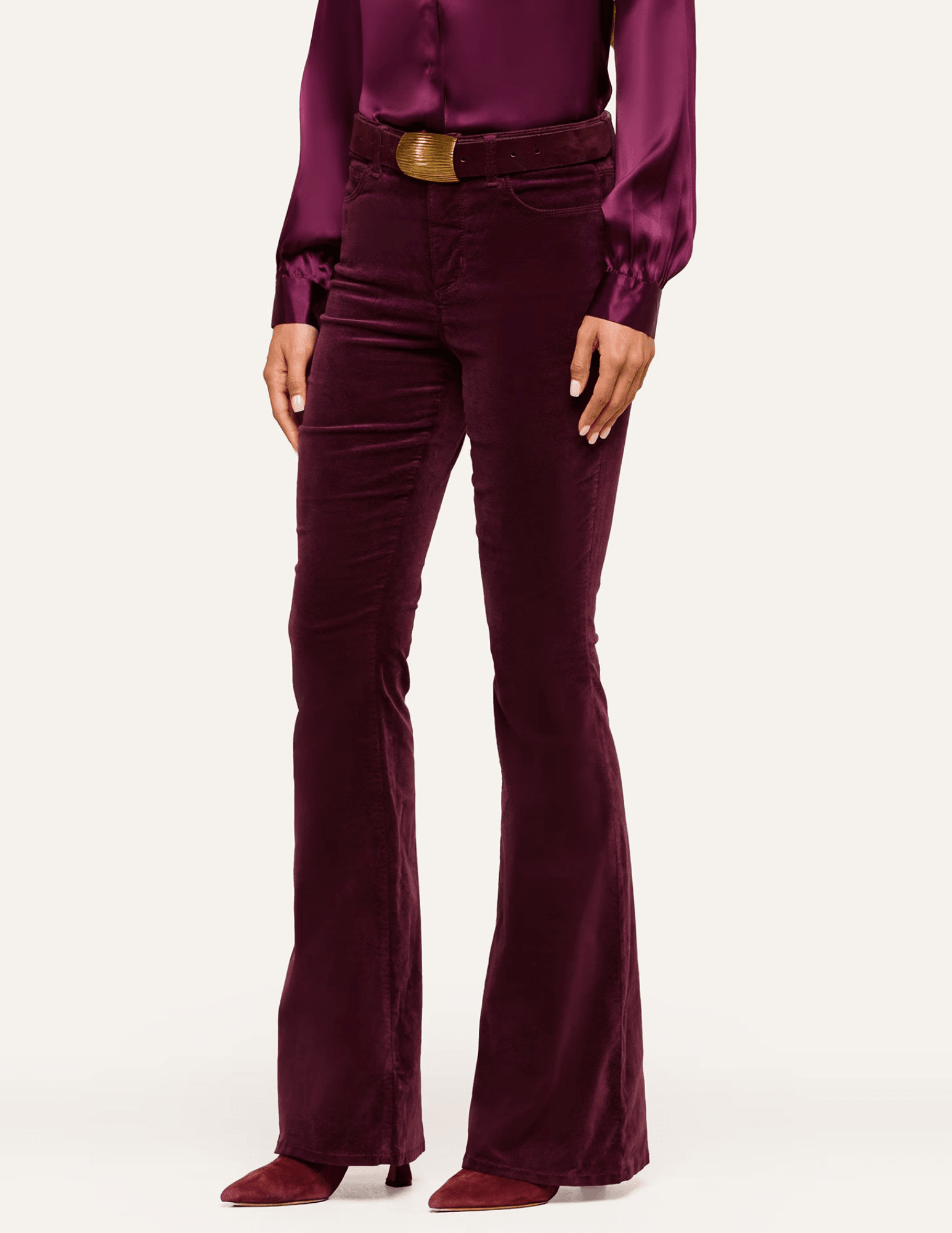 SIde view of L'AGENCE Marty Velvet Ultra High Rise Jeans in Deep Sangria featuring classic back pockets and flared legs.