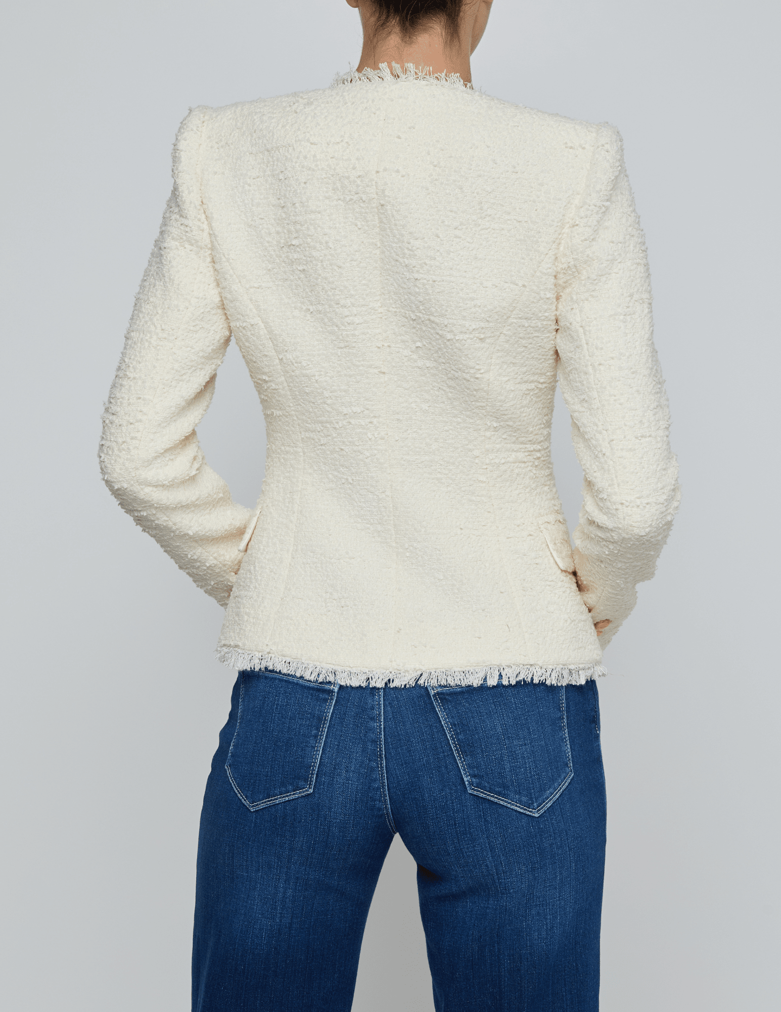 Back view of L’AGENCE Nerina collarless structured blazer in ivory with gold logo buttons
