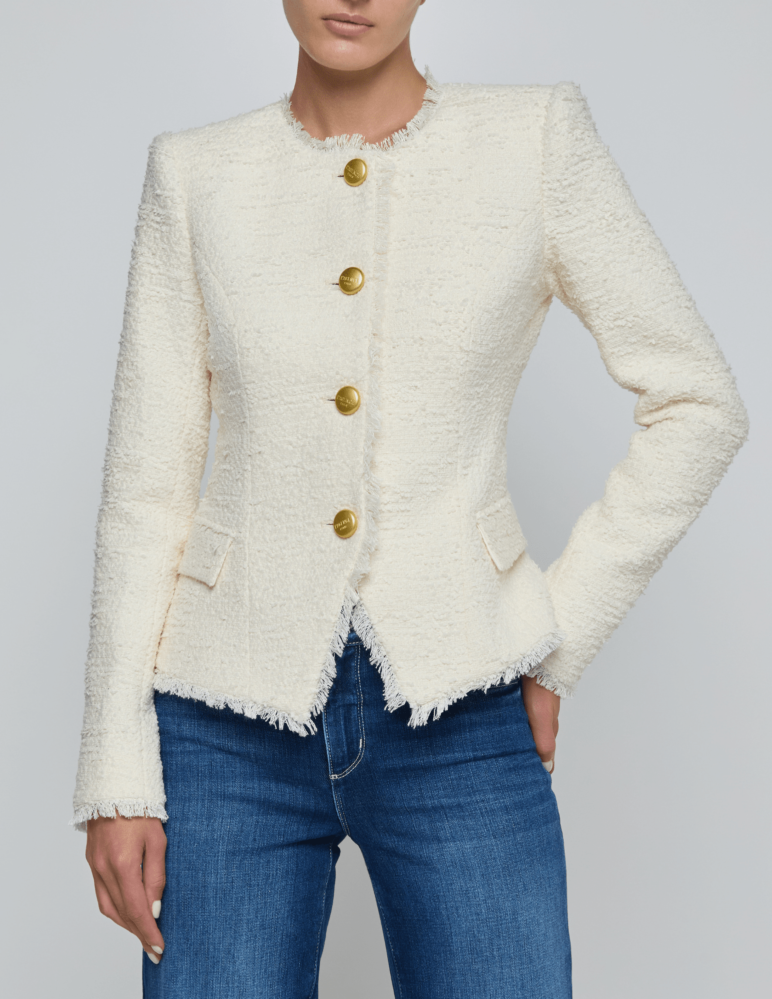 Front view of L’AGENCE Nerina collarless structured blazer in ivory with gold logo buttons
