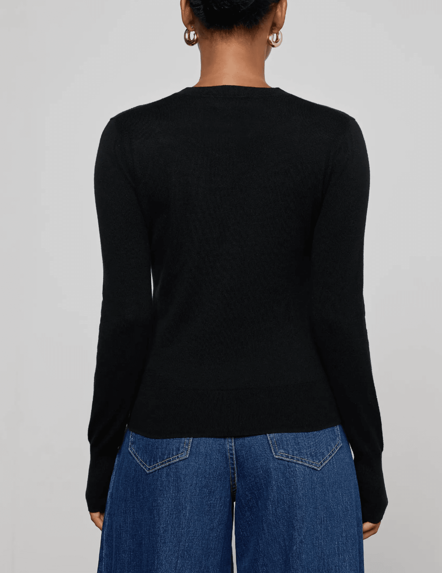 Back view of L’AGENCE Ronda long sleeve knit henley top in black