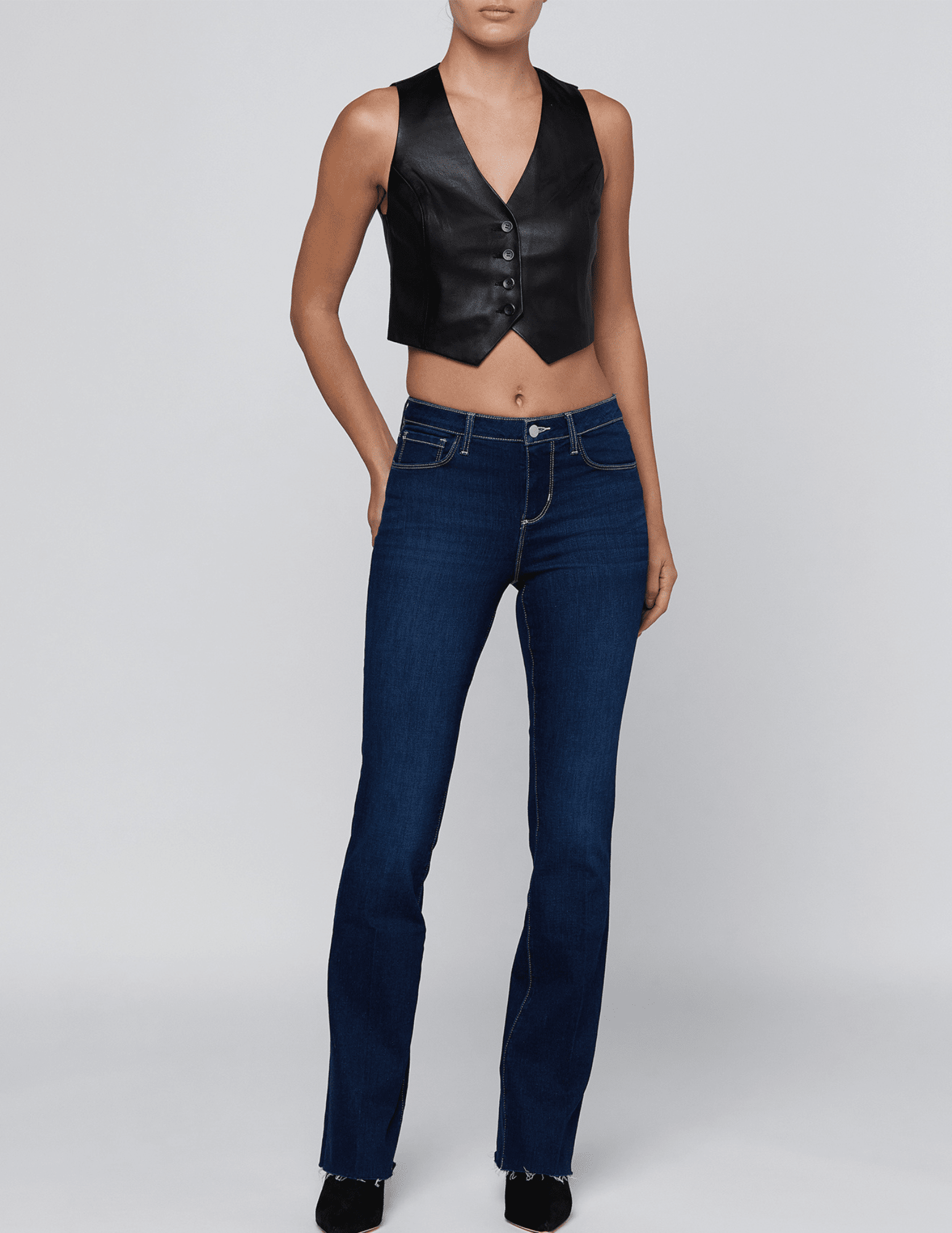 L'AGENCE Ruth Straight Leg Jeans in Robles styled with a black sleeveless leather vest and heels for a chic denim outfit.