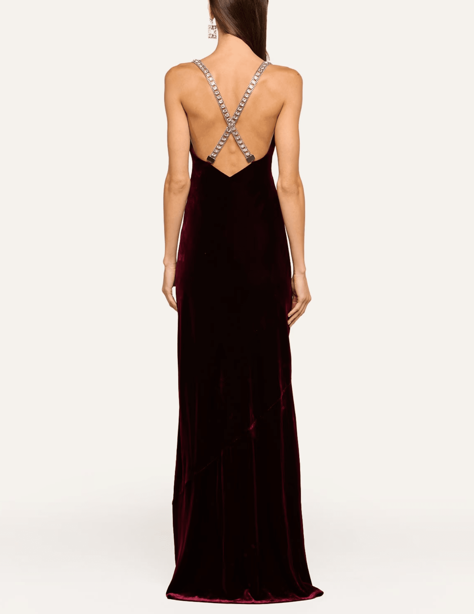 Back view of L'AGENCE Saint velvet gown featuring sparkling rhinestone crisscross straps and dramatic open back
