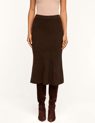 Model wearing L'AGENCE Salem Dark Brown Knit Midi Skirt with a fitted silhouette and flared hem.