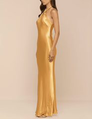 Side view of L’AGENCE Saphara Halter Gown in Dark Gold