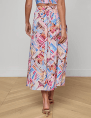 Back view of L'Agence Seina midi skirt in pink postcard print