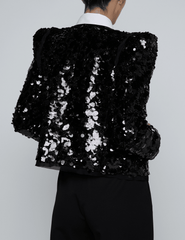 Back view of L’AGENCE Shai Sequin Pointed Shoulder Jacket in black sequins.