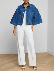 Model styling L'AGENCE Silas Cape Denim Jacket in Orwood with white trousers