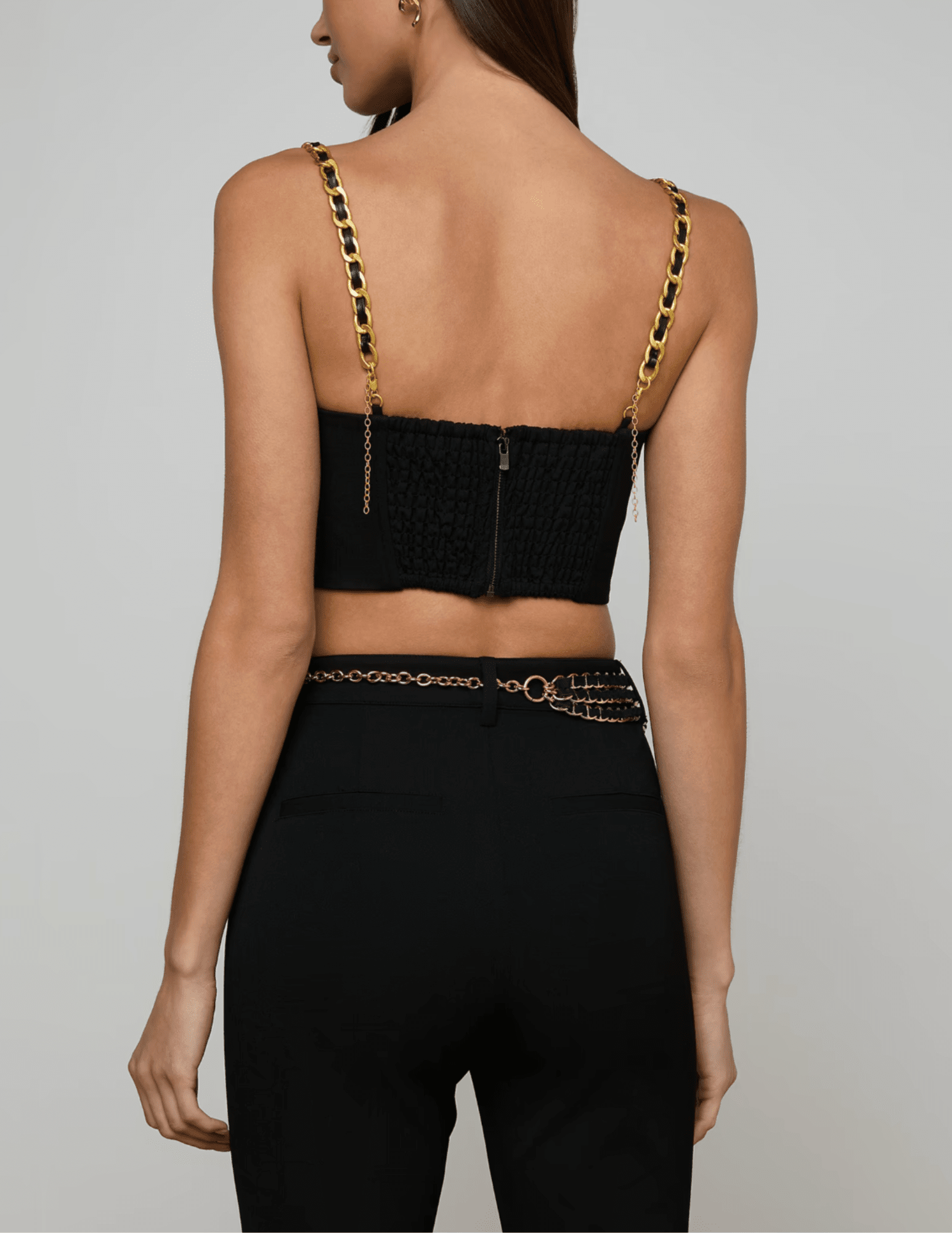 Back view of structured black bustier top with gold buttons