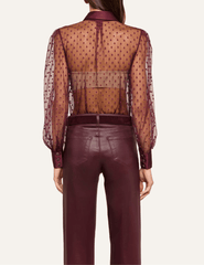 Back view of L'AGENCE Sophie Swiss Dot Blouse in Deep Port showcasing its sheer fabric and elegant silhouette.