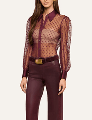 Angled view of L'AGENCE Sophie Sheer Swiss Dot Blouse highlighting its delicate dotted pattern and long sleeves.