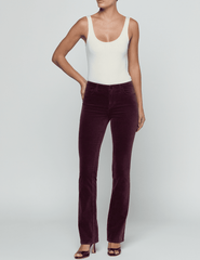 Full-length model wearing L'AGENCE Stevie Velvet Jean in Deep Sangria.