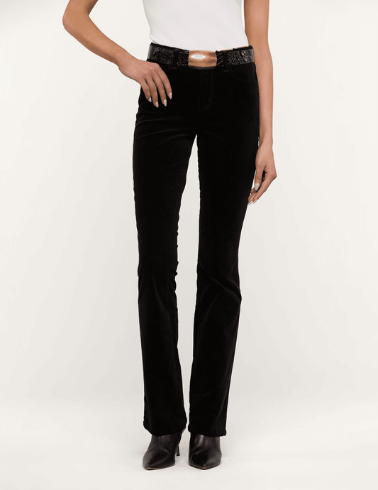 Model wearing L'AGENCE Stevie black velvet straight-leg jeans with high-rise waistband