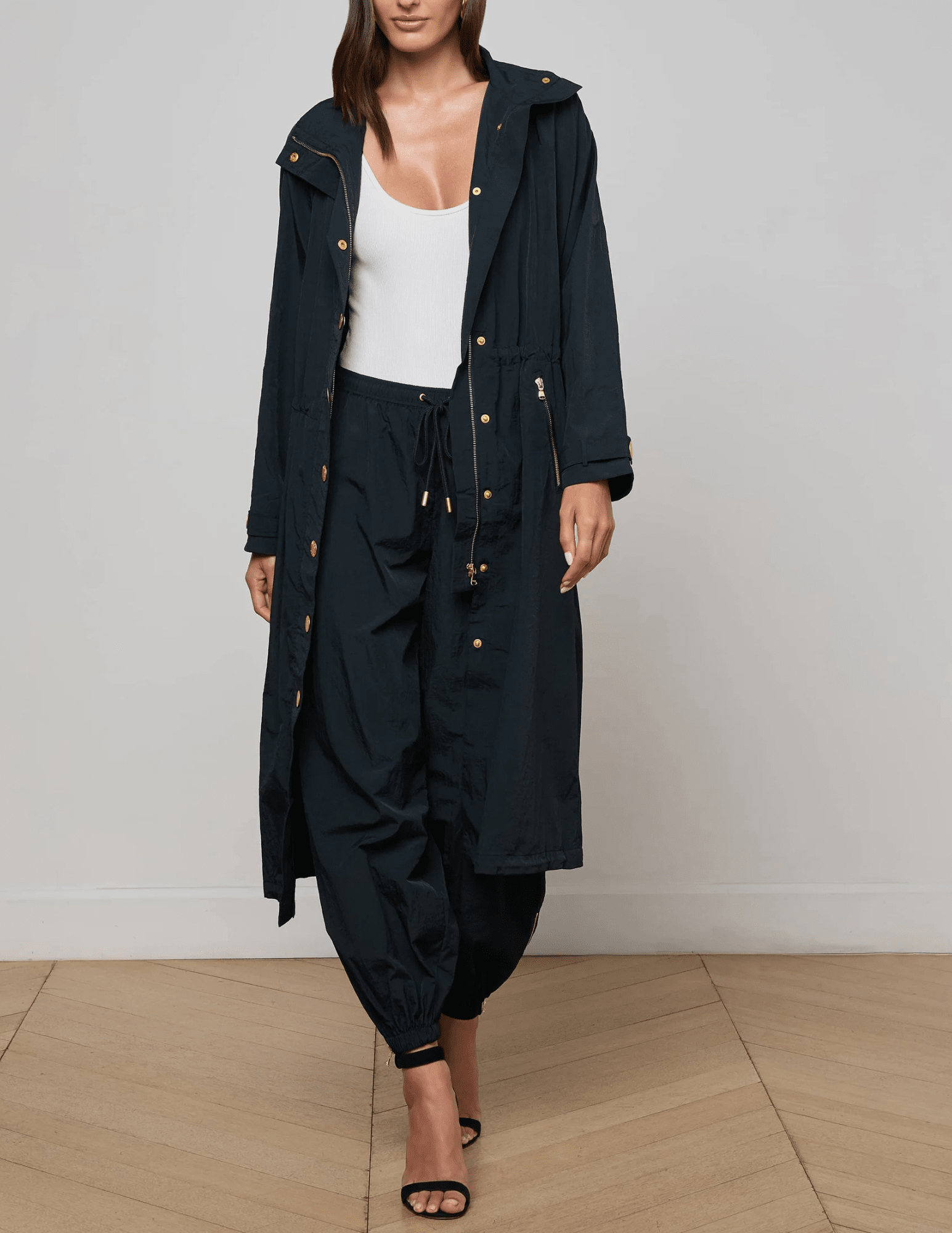 Full length designer trench coat in black with drawstring waist and snap button closure front model view