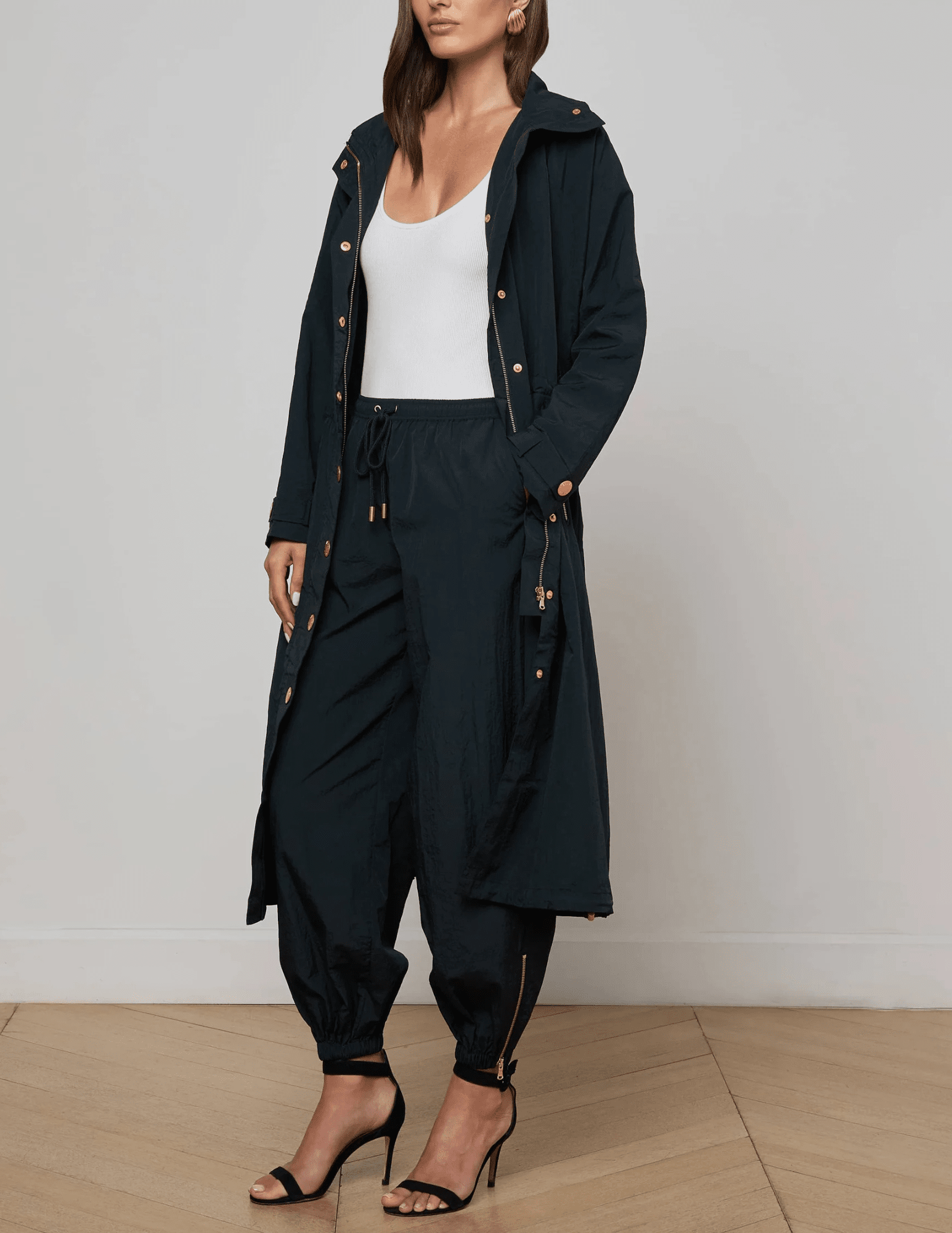 Full length designer trench coat in black with drawstring waist and snap button closure side model view